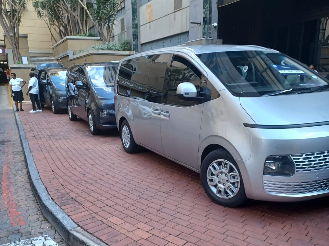 Three Foreverlit vehicles lined up at a kerbside pickup, a silver Hyundai Staria at the front